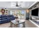 Comfortable living room boasts a fireplace, sliding glass doors, and modern furnishings at 4523 Gulfstream Dr, Hernando Beach, FL 34607