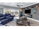 A cozy living room includes a fireplace, wall-mounted TV, stylish decor, and comfortable seating for Gathering and guests at 4523 Gulfstream Dr, Hernando Beach, FL 34607
