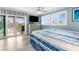 Comfortable bedroom with balcony access, TV, and serene waterfront view at 4523 Gulfstream Dr, Hernando Beach, FL 34607