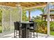 Enjoy outdoor dining on the covered patio, complete with a table, chairs, and views of the waterfront and lush greenery at 4523 Gulfstream Dr, Hernando Beach, FL 34607