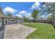 This backyard has a large patio, a gazebo, and lush green grass for outdoor enjoyment at 4619 W Bay Villa Ave, Tampa, FL 33611