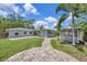 Lush backyard featuring a beautiful gazebo, a well-manicured lawn, a patio and verdant tree life at 4619 W Bay Villa Ave, Tampa, FL 33611