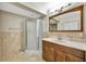 The bathroom showcases a glass door shower, wood vanity, and ceramic tile throughout the room at 4619 W Bay Villa Ave, Tampa, FL 33611