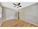 This bedroom has hardwood floors, a ceiling fan, and a closet with sliding doors at 4619 W Bay Villa Ave, Tampa, FL 33611