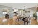 Staged dining room area that flows into an updated kitchen with stainless steel appliances and breakfast bar at 4619 W Bay Villa Ave, Tampa, FL 33611