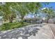 View of a well-maintained home featuring a spacious driveway, healthy green lawn, and mature shade trees at 4619 W Bay Villa Ave, Tampa, FL 33611