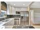 Contemporary kitchen with stainless steel appliances, white cabinets and gray subway tile at 4619 W Bay Villa Ave, Tampa, FL 33611