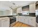 Modern kitchen with stainless steel appliances, white cabinetry, and subway tile backsplash at 4619 W Bay Villa Ave, Tampa, FL 33611
