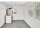 Functional laundry room featuring a washer and dryer hookup with a window and air conditioning unit at 4619 W Bay Villa Ave, Tampa, FL 33611