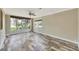 Spacious living room filled with natural light, featuring wood-look tile floors and neutral paint at 4619 W Bay Villa Ave, Tampa, FL 33611