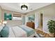 Stylishly staged main bedroom boasting hardwood floors, chic decor, and access to an attached bathroom at 4619 W Bay Villa Ave, Tampa, FL 33611