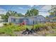 View of the backyard and exterior of the property showing landscaping and a partial fence at 5048 5Th S Ave, St Petersburg, FL 33707