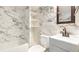 An updated bathroom offers decorative tile throughout, vanity sink, and a tub at 5048 5Th S Ave, St Petersburg, FL 33707