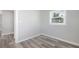 This bedroom features light hardwood floors, white walls, and a window for great natural light at 5048 5Th S Ave, St Petersburg, FL 33707