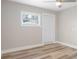 This bedroom features light hardwood floors, white walls, and a window for great natural light at 5048 5Th S Ave, St Petersburg, FL 33707