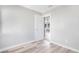 This bedroom features light hardwood floors, white walls, and a view to the rest of the house at 5048 5Th S Ave, St Petersburg, FL 33707
