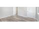 This bedroom features modern light-colored walls and beautiful wood-look floors at 5048 5Th S Ave, St Petersburg, FL 33707