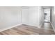 Bedroom has light hardwood floors, white walls, closet, and a view to the rest of the house at 5048 5Th S Ave, St Petersburg, FL 33707