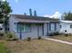 Attractive single-story home featuring a covered porch and a well-kept front lawn with a sidewalk at 5048 5Th S Ave, St Petersburg, FL 33707