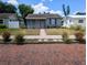 Charming single-story home featuring a walkway, tidy landscaping, and classic architectural details at 5048 5Th S Ave, St Petersburg, FL 33707