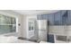 Modern kitchen boasts stainless steel refrigerator, blue cabinets, and bright countertop at 5048 5Th S Ave, St Petersburg, FL 33707