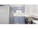 Modern kitchen with stainless steel refrigerator, white countertops, and stylish blue cabinets at 5048 5Th S Ave, St Petersburg, FL 33707