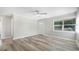 Bright and airy living room with sleek flooring and ample natural light streaming through the window at 5048 5Th S Ave, St Petersburg, FL 33707