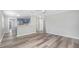 Open-concept living area with stylish wood floors and a view of the modern kitchen at 5048 5Th S Ave, St Petersburg, FL 33707