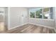 Bright room with wooden floors, white walls, and large windows providing plenty of natural light at 5048 5Th S Ave, St Petersburg, FL 33707