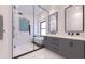 Modern bathroom featuring a glass-enclosed shower, soaking tub, and dual vanity at 5200 7Th N Ave, St Petersburg, FL 33710