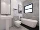 Modern bathroom featuring a sleek vanity, toilet, soaking tub and a window for natural light at 5200 7Th N Ave, St Petersburg, FL 33710