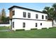 Side exterior highlighting the home's design, with a view of the well-kept lawn and side entrance at 5200 7Th N Ave, St Petersburg, FL 33710