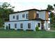 Rear exterior showcasing the modern design, many windows, and green lawn at 5200 7Th N Ave, St Petersburg, FL 33710