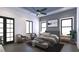 Serene bedroom with large windows, stylish decor, and ceiling fan at 5200 7Th N Ave, St Petersburg, FL 33710