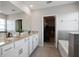 Bright bathroom featuring a double vanity with granite counters and a walk-in closet at 5214 Granite Dust Pl, Palmetto, FL 34221