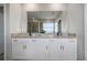 Bathroom featuring a double sink vanity with granite counters and a large mirror at 5214 Granite Dust Pl, Palmetto, FL 34221