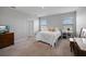 Serene bedroom with natural light, plush bedding, and simple decor for a peaceful and inviting space at 5214 Granite Dust Pl, Palmetto, FL 34221
