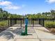 Community dog park featuring a fenced-in area, water fountain, and lush landscaping for residents' furry friends at 5214 Granite Dust Pl, Palmetto, FL 34221