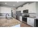 Spacious kitchen features stainless steel appliances, granite countertops and all white cabinets at 5214 Granite Dust Pl, Palmetto, FL 34221