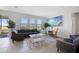 Bright living room featuring large windows, comfortable seating, and stylish decor, creating a welcoming atmosphere at 5214 Granite Dust Pl, Palmetto, FL 34221