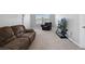 Cozy living room with plush seating, neutral carpet, and a mounted TV at 5214 Granite Dust Pl, Palmetto, FL 34221
