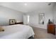 Bright main bedroom with carpet flooring, neutral tones, and a mirror at 5214 Granite Dust Pl, Palmetto, FL 34221