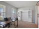 Spacious home office with built-in shelving, large desk, and comfortable seating, perfect for productivity at 5214 Granite Dust Pl, Palmetto, FL 34221