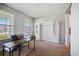 Bright home office with built-in shelving, large desk, and comfortable seating, perfect for productivity at 5214 Granite Dust Pl, Palmetto, FL 34221