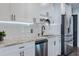 Stylish kitchen featuring granite counters, stainless appliances and modern lighting at 5509 Bluejay Ln, Tampa, FL 33625