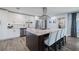 Modern kitchen featuring white cabinetry, stainless appliances and a large center island at 5509 Bluejay Ln, Tampa, FL 33625