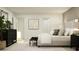 Modern bedroom featuring a large bed, neutral tones, art, and plant accents, creating a calm space at 5739 Yellow Hornbill Ave, Wimauma, FL 33598