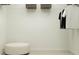 Organized closet featuring hanging clothes, baskets, shelving, and an ottoman on neutral carpet at 5739 Yellow Hornbill Ave, Wimauma, FL 33598