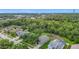 Aerial view of a quaint neighborhood with mature trees and proximity to commercial areas at 5809 Silas Creek Ln, Wesley Chapel, FL 33545