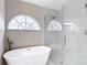 Elegant bathroom featuring a standalone tub and frameless shower with sophisticated design at 5809 Silas Creek Ln, Wesley Chapel, FL 33545